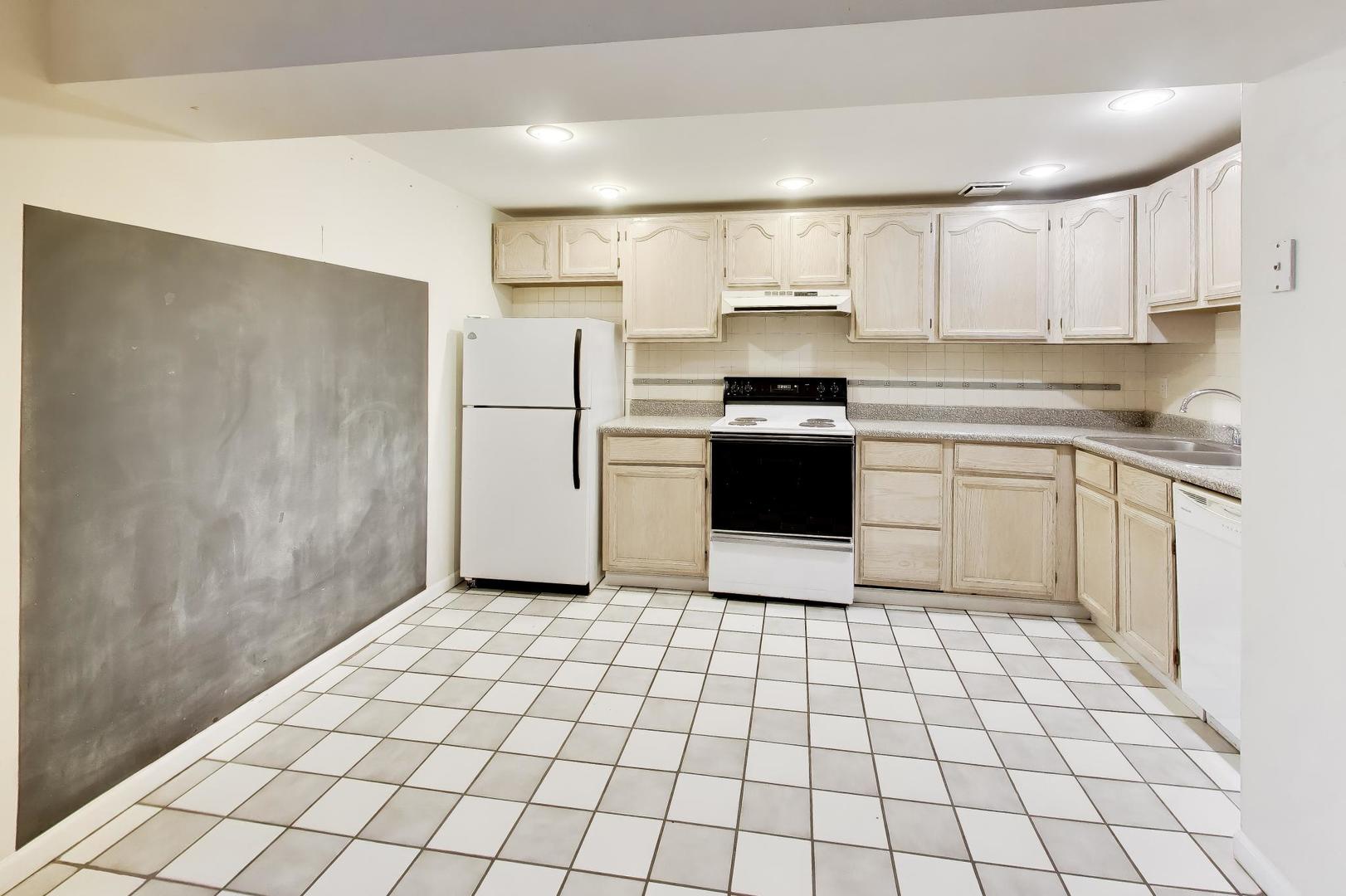 2629 North Troy Street Chicago, IL 60647 - Photo 12 of 16 a kitchen with a stove a sink and a refrigerator