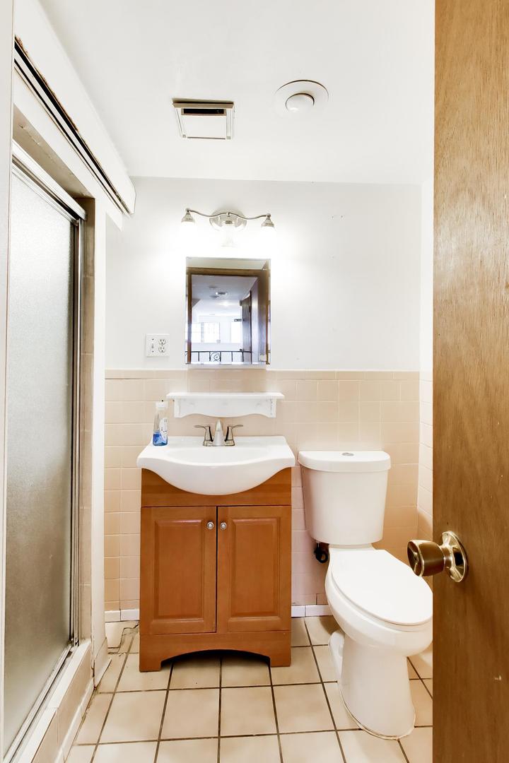 2629 North Troy Street Chicago, IL 60647 - Photo 13 of 16 a bathroom with a sink a toilet and mirror