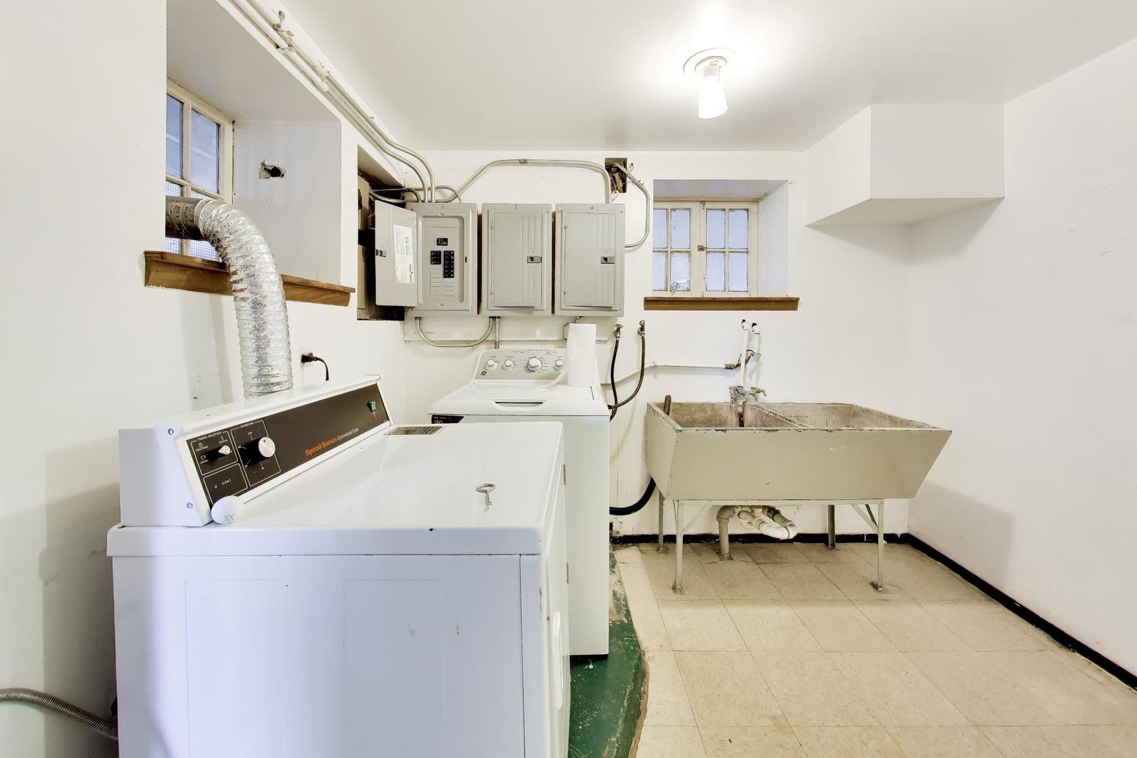 2629 North Troy Street Chicago, IL 60647 - Photo 14 of 16 a view of a kitchen with stainless steel appliances wooden floor and a refrigerator