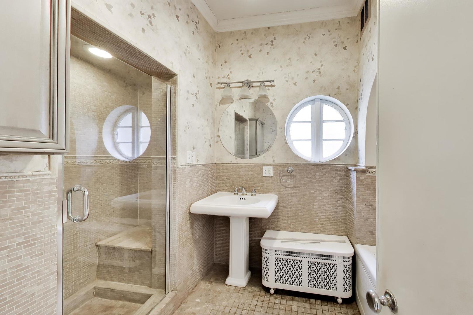 2629 North Troy Street Chicago, IL 60647 - Photo 9 of 16 a bathroom with a sink and a mirror