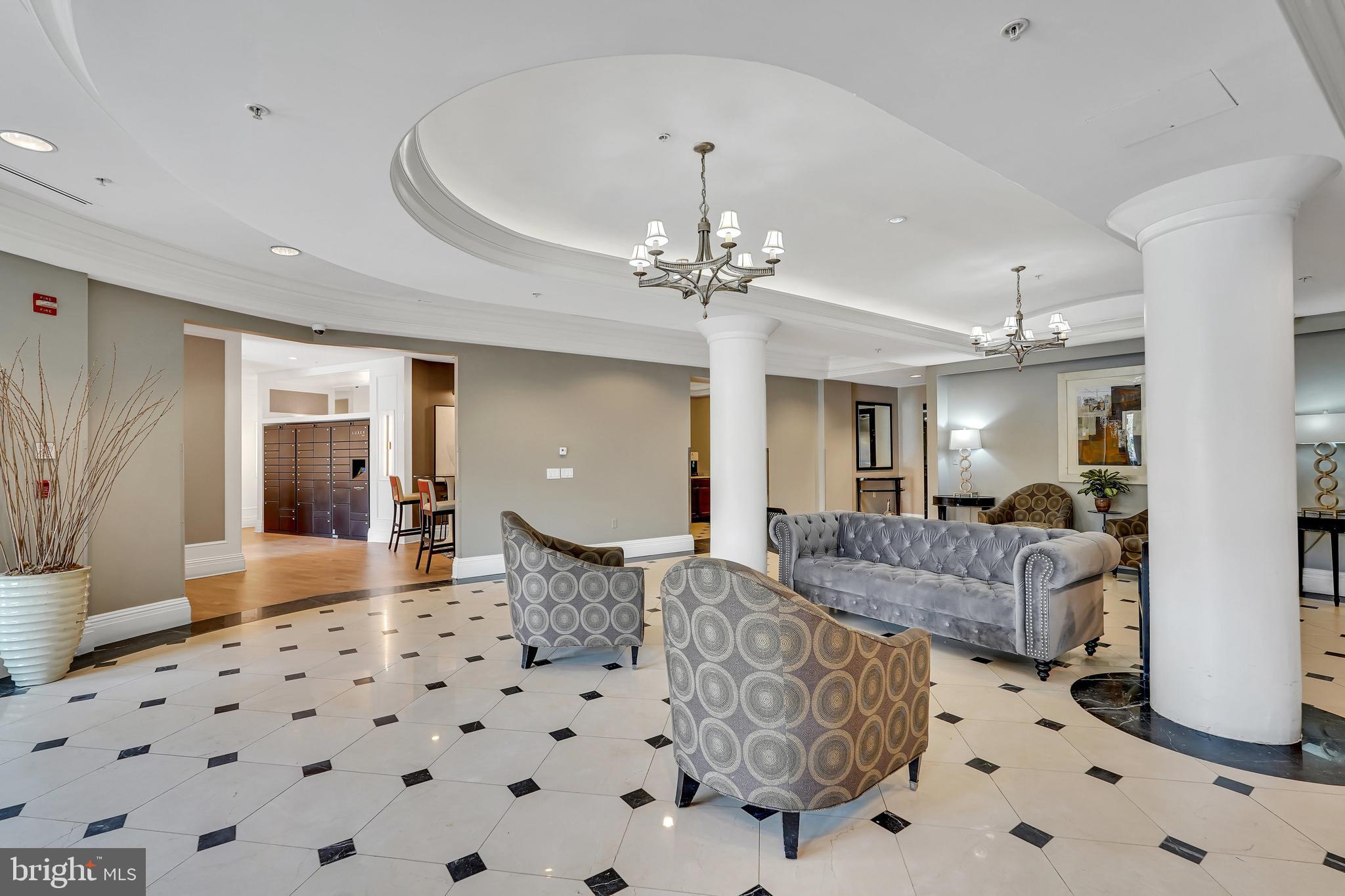 3401 38th Street Northwest, Unit 407 Washington, DC 20016 - Photo 14 of 28 a living room with furniture and a chandelier