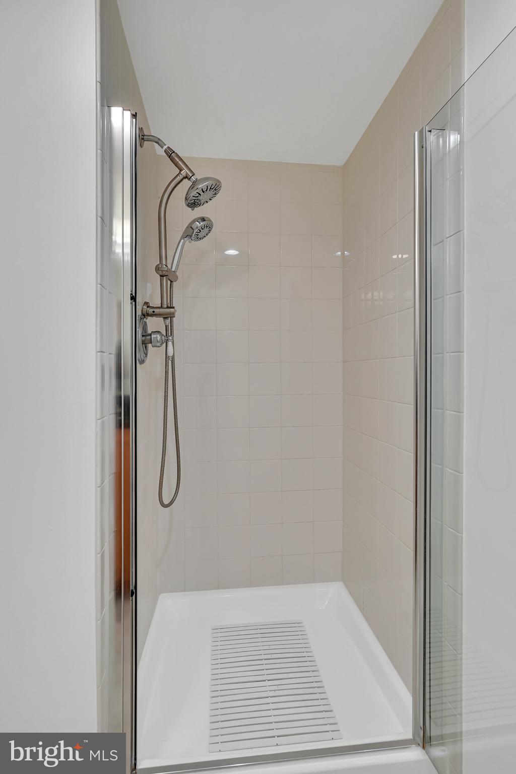 3401 38th Street Northwest, Unit 407 Washington, DC 20016 - Photo 5 of 28 a bathroom with a glass shower door
