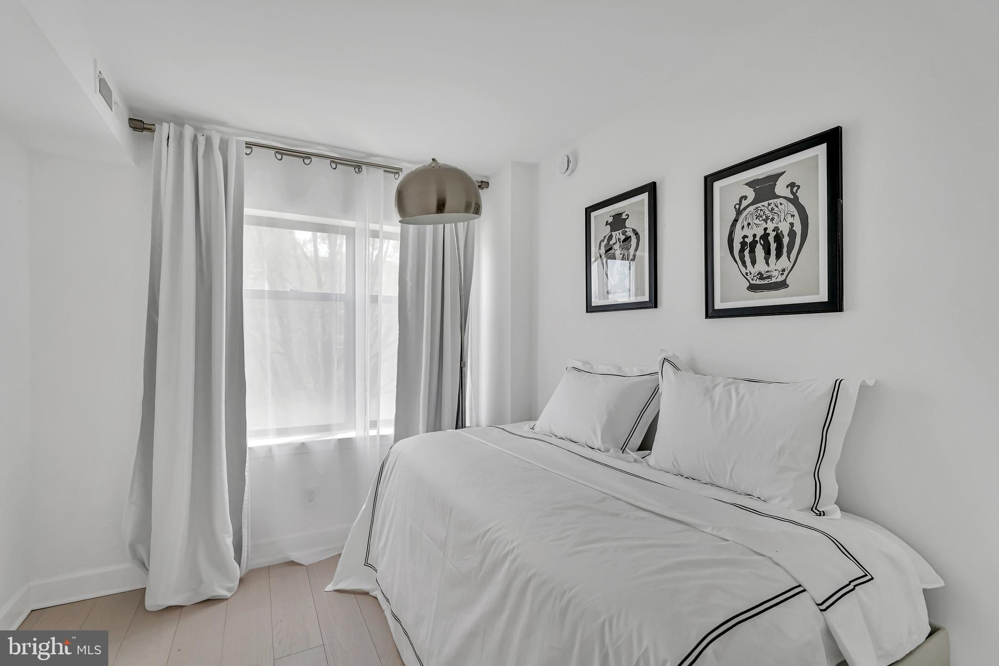 3401 38th Street Northwest, Unit 407 Washington, DC 20016 - Photo 6 of 28 a bedroom with a bed and a window