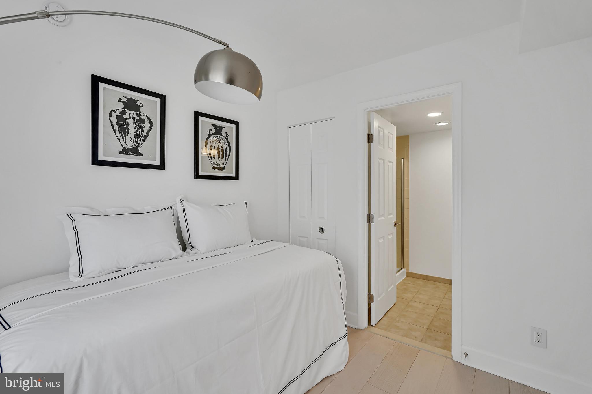 3401 38th Street Northwest, Unit 407 Washington, DC 20016 - Photo 7 of 28 a bedroom with a large bed and painting on the wall