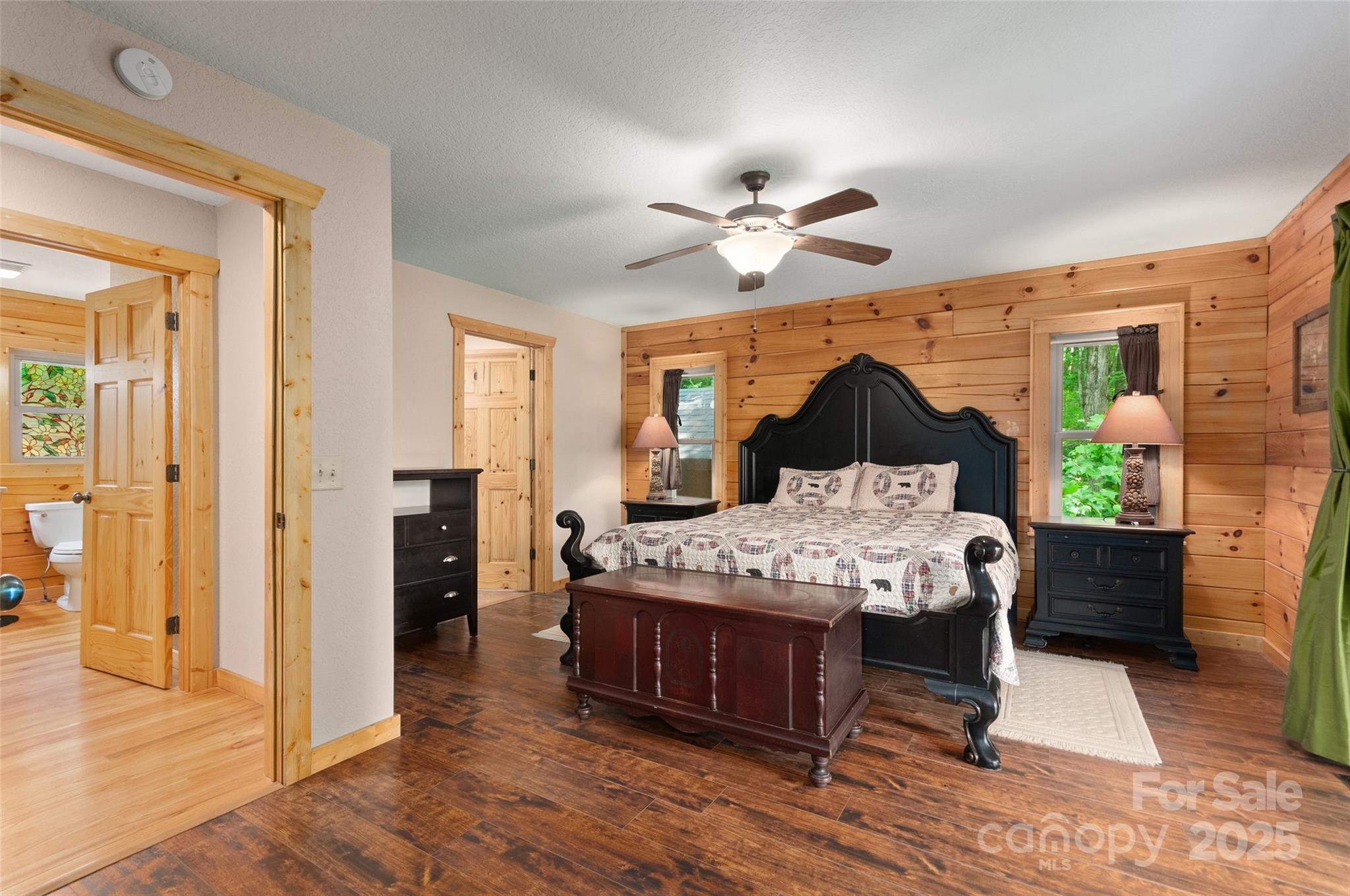 314 Prosperity Ridge Waynesville, NC 28785 - Photo 16 of 48 a bedroom with a bed chandelier and a window