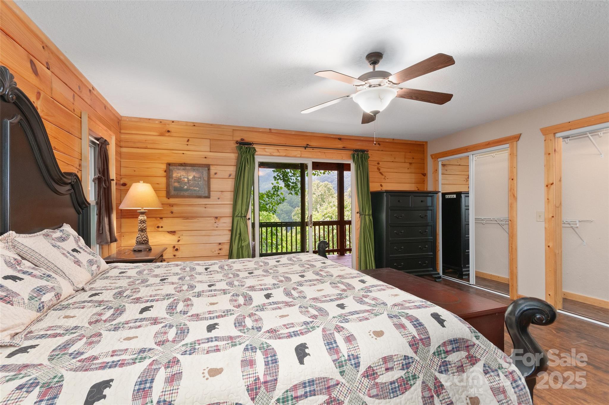 314 Prosperity Ridge Waynesville, NC 28785 - Photo 17 of 48 a bedroom with a large bed and a chandelier