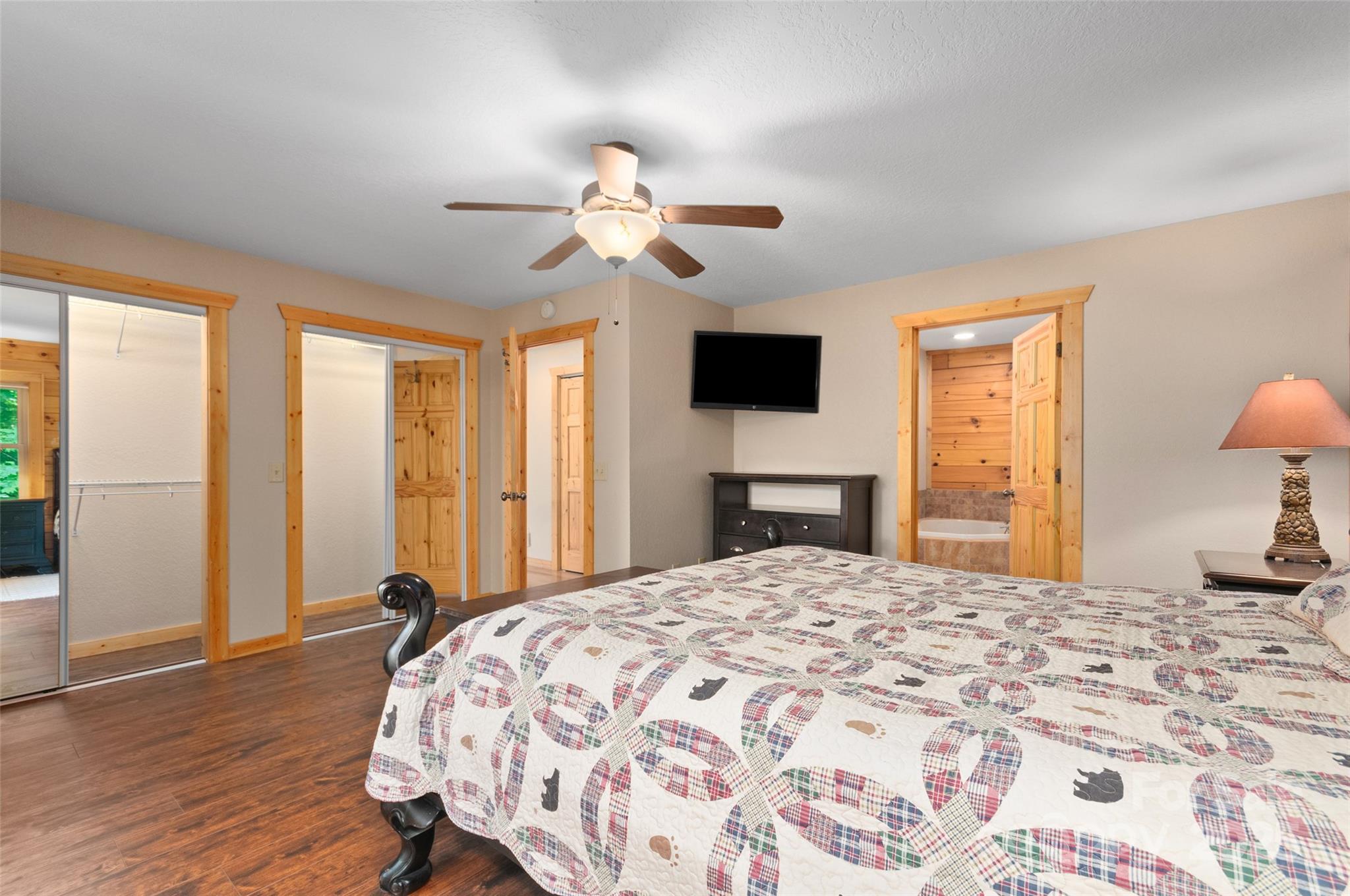 314 Prosperity Ridge Waynesville, NC 28785 - Photo 18 of 48 a bedroom with a bed and a chandelier