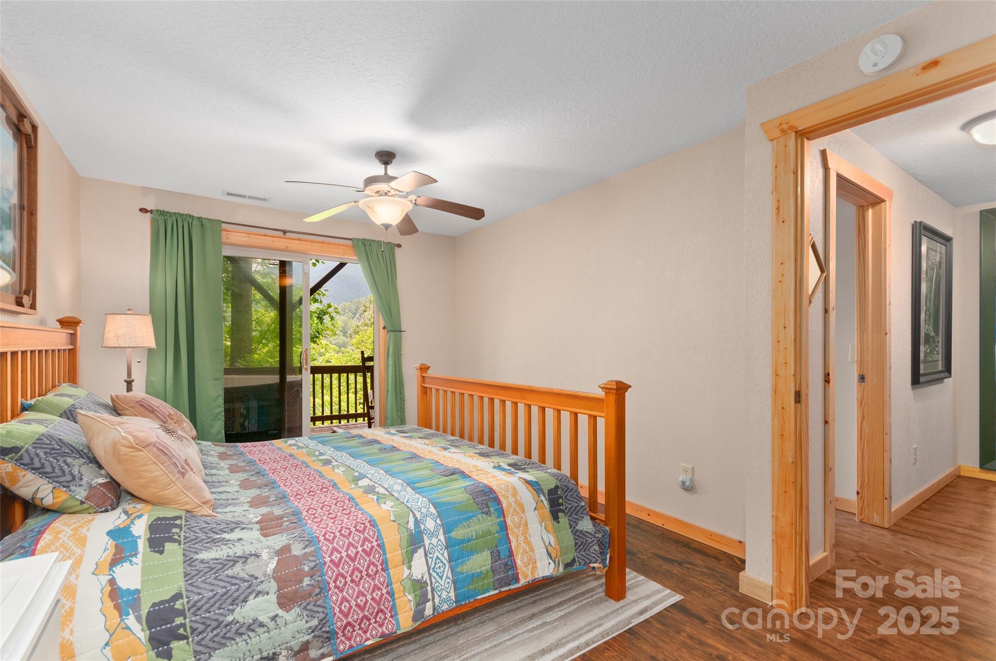 314 Prosperity Ridge Waynesville, NC 28785 - Photo 28 of 48 a bedroom with a bed and a chandelier
