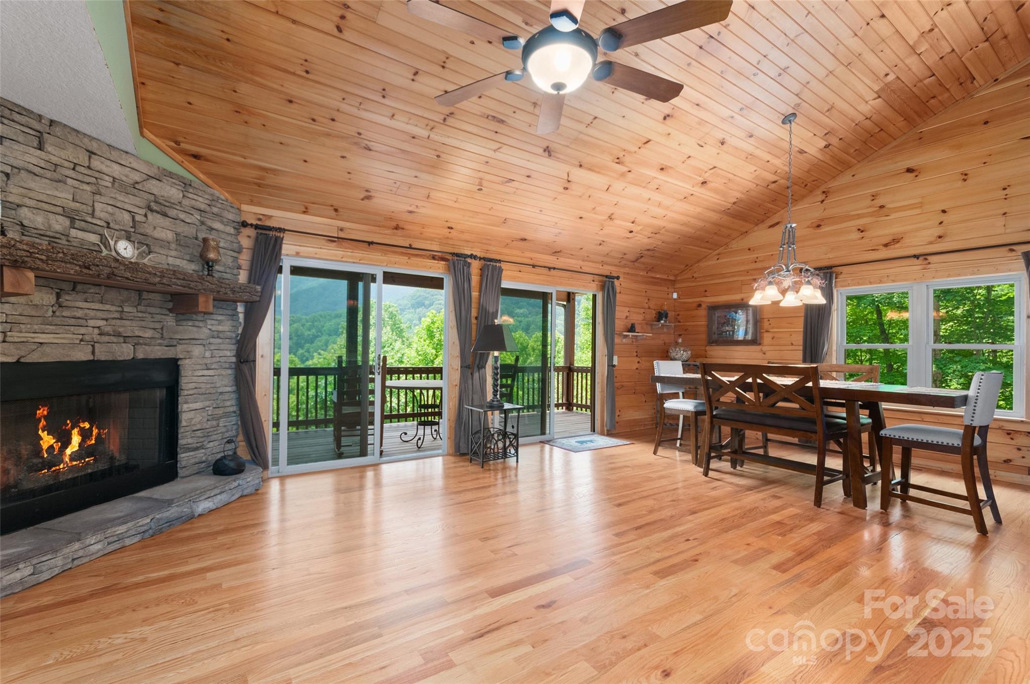 314 Prosperity Ridge Waynesville, NC 28785 - Photo 5 of 48 a dining room with furniture a fireplace and wooden floor