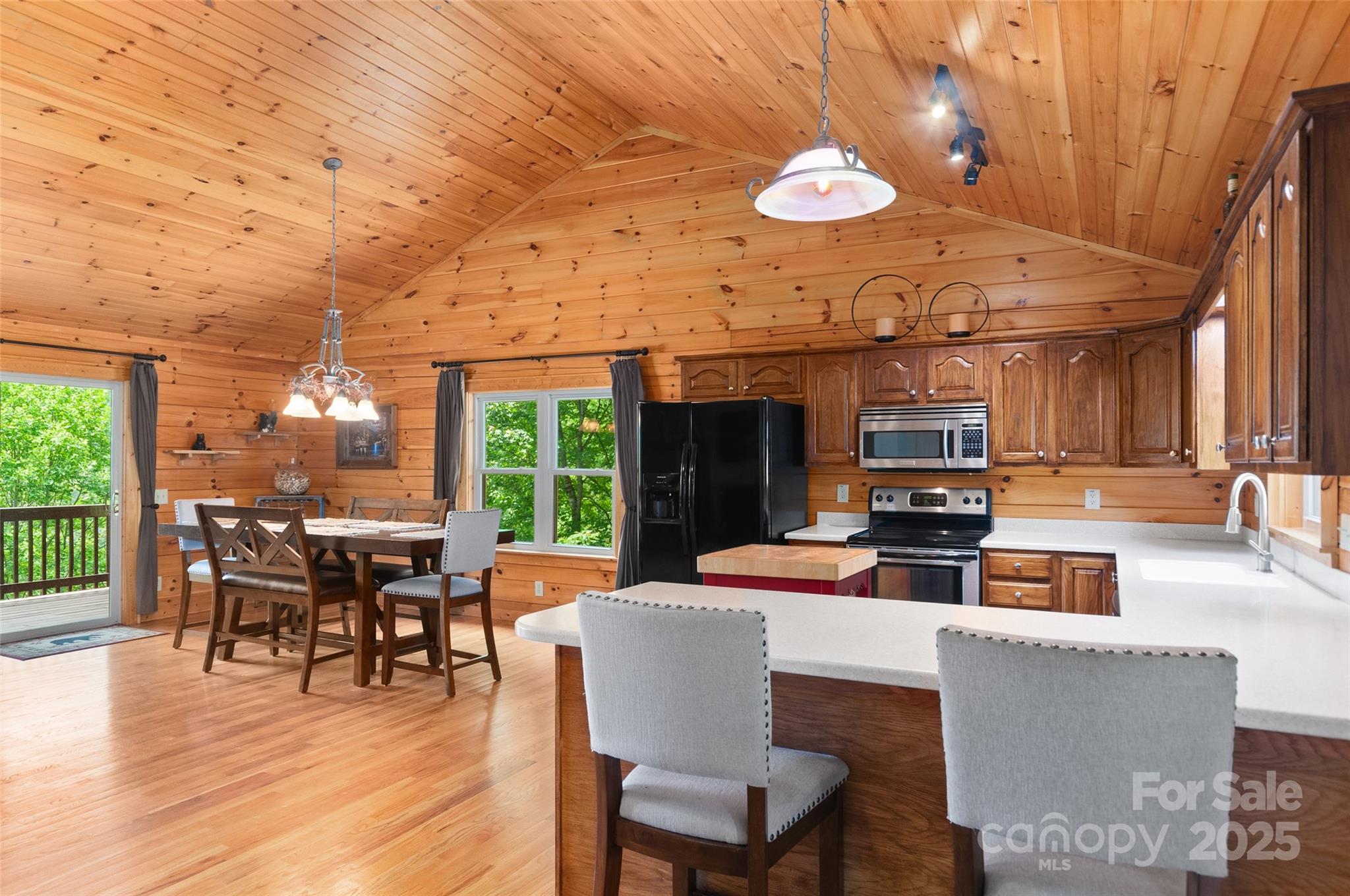 314 Prosperity Ridge Waynesville, NC 28785 - Photo 8 of 48 a dining room with wooden floor and large windows