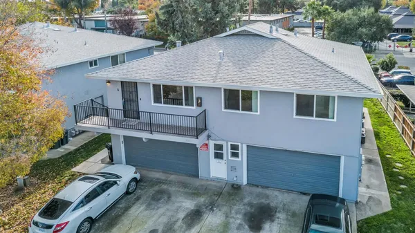 a front view of house with deck and yard