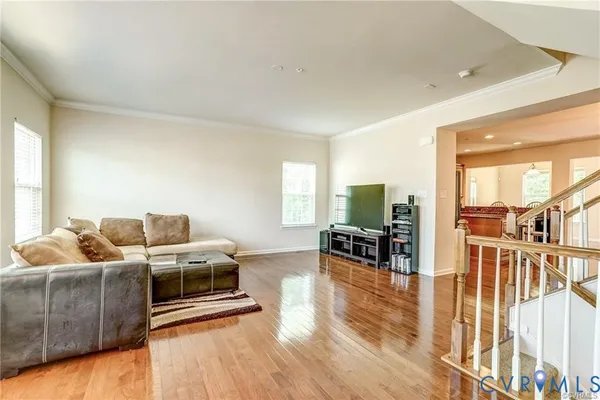 a living room with furniture and wooden floor