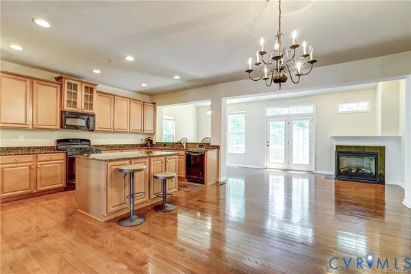 a view of kitchen with sink and refrigerator