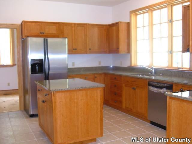 3908 Atwood Road Stone Ridge, NY 12484 - Photo 3 of 3 a kitchen with stainless steel appliances granite countertop a sink and a refrigerator