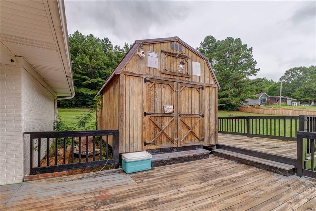 4244 Prior Station Road Cedartown, GA 30125 - Photo 18 of 51 a view of a wooden deck with a yard