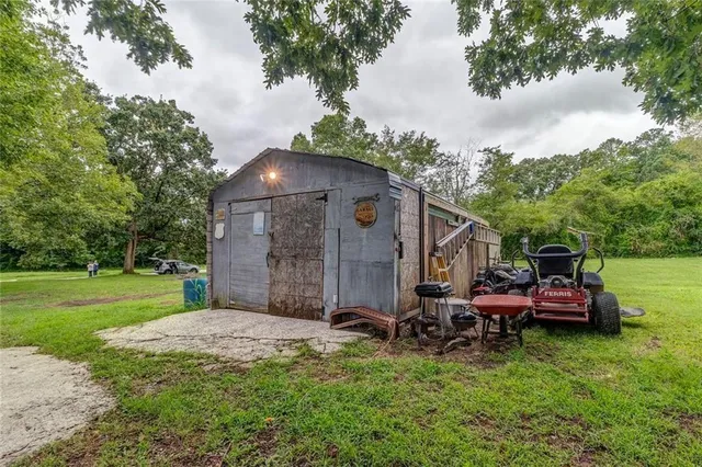 a view of a chair and table in backyard of the house
