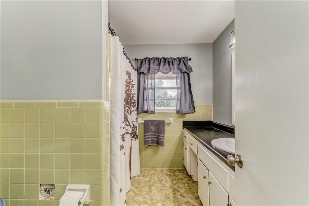 4244 Prior Station Road Cedartown, GA 30125 - Photo 48 of 51 a bathroom with a granite countertop sink a mirror and a shower