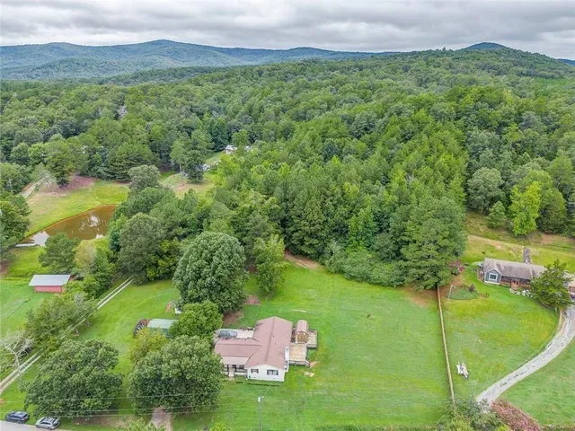 a view of a lush green outdoor space with a lake view and mountain view