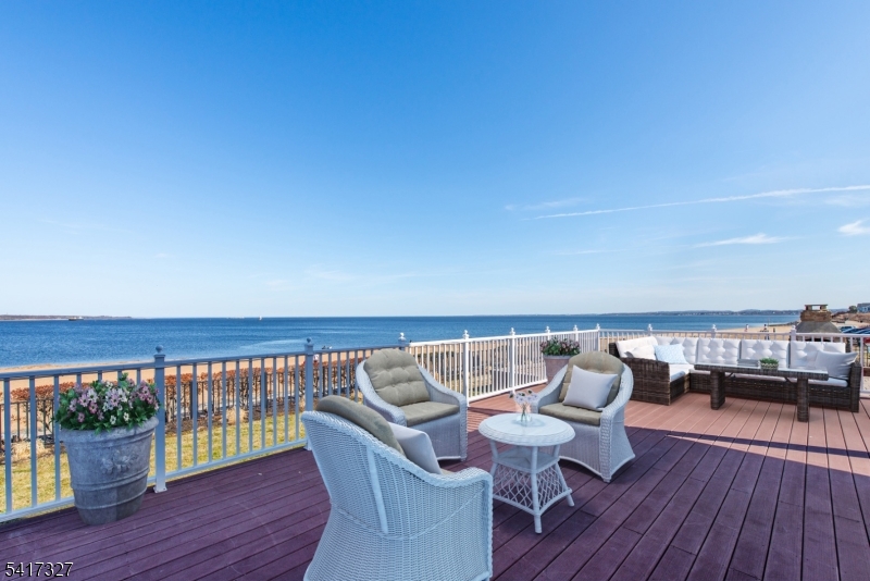 76 Raritan Reach Road South Amboy, NJ 08879 - Photo 12 of 42 a roof deck with a table and chairs