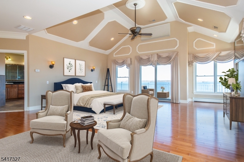 76 Raritan Reach Road South Amboy, NJ 08879 - Photo 18 of 42 a bedroom with a bed and a chandelier