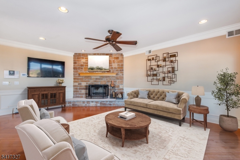 76 Raritan Reach Road South Amboy, NJ 08879 - Photo 9 of 42 a living room with furniture a fireplace and a flat screen tv