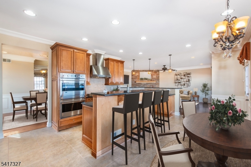 76 Raritan Reach Road South Amboy, NJ 08879 - Photo 10 of 42 a kitchen with stainless steel appliances kitchen island granite countertop a table and chairs in it