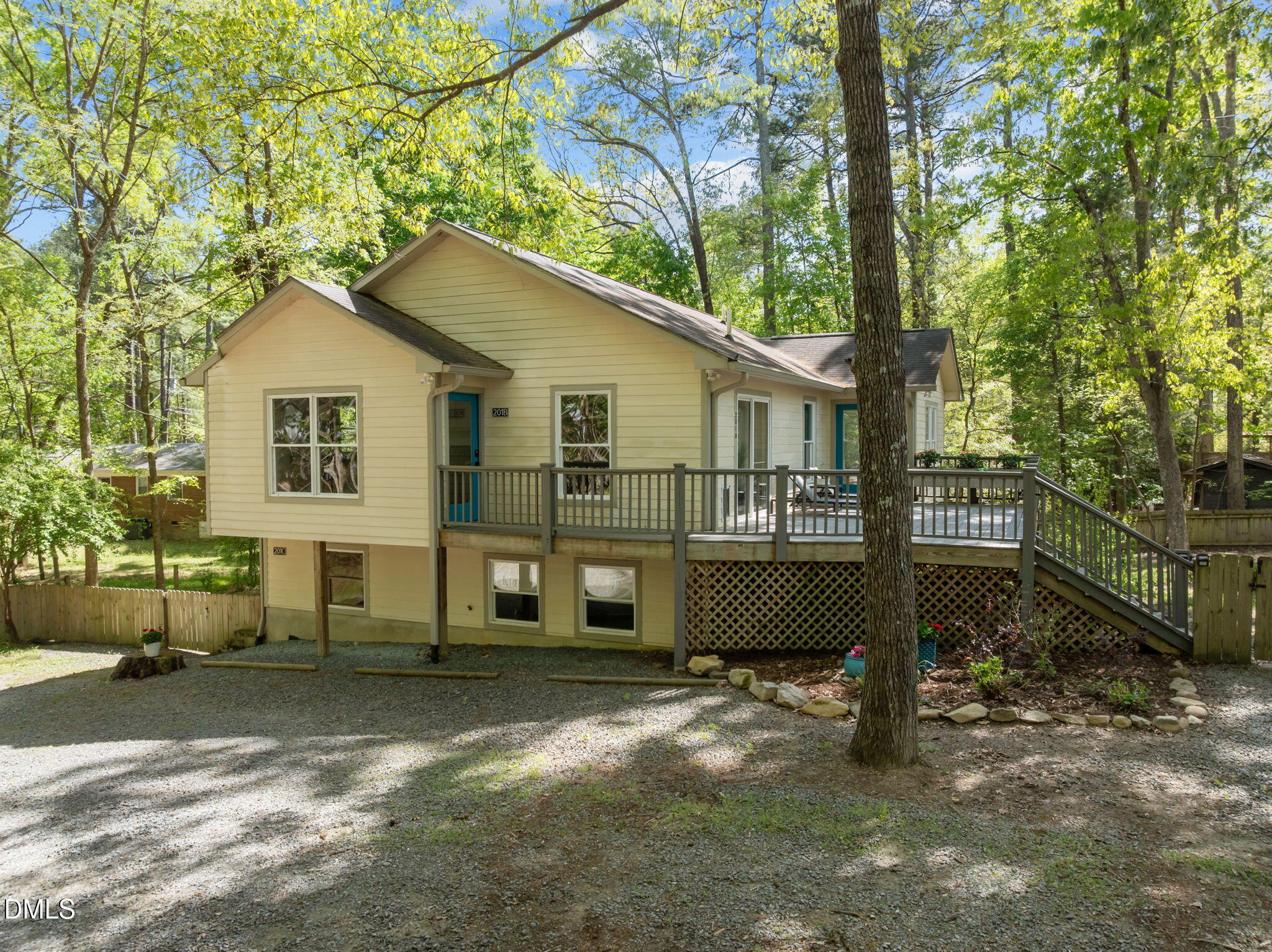 a view of a house with a yard and sitting area