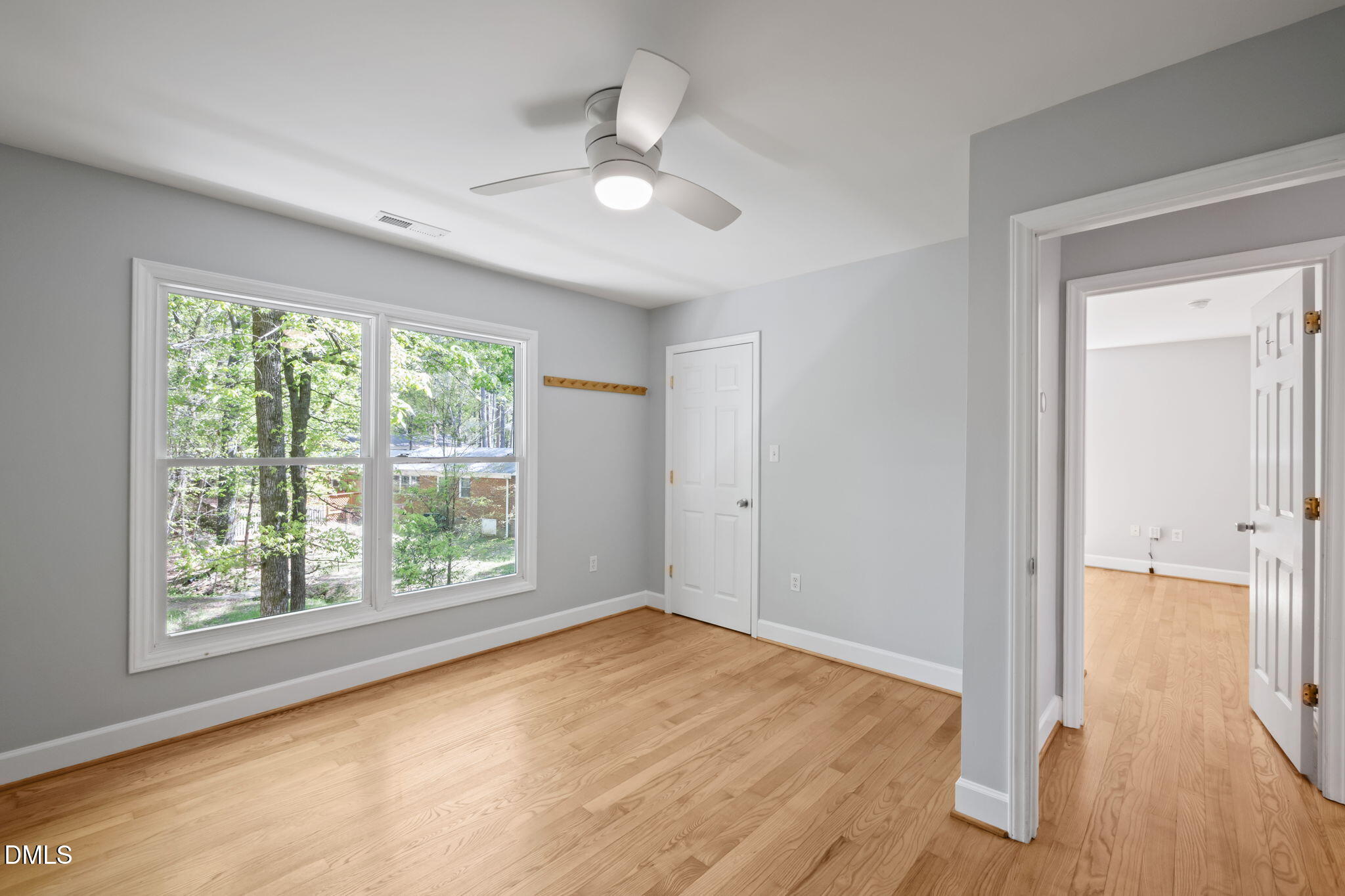 201 Simpson Street, Unit B Carrboro, NC 27510 - Photo 17 of 56 an empty room with wooden floor and windows