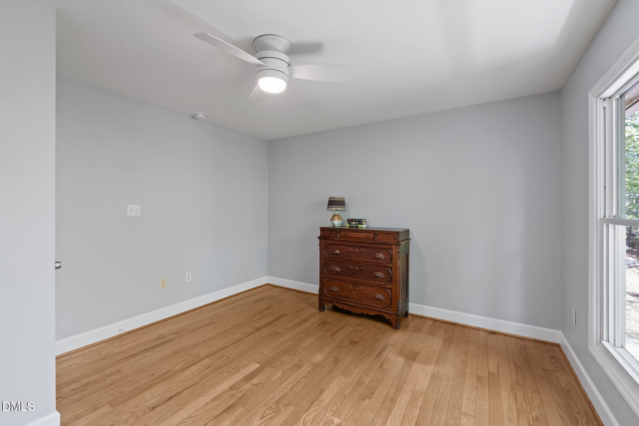 201 Simpson Street, Unit B Carrboro, NC 27510 - Photo 18 of 56 an empty room with wooden floor and windows