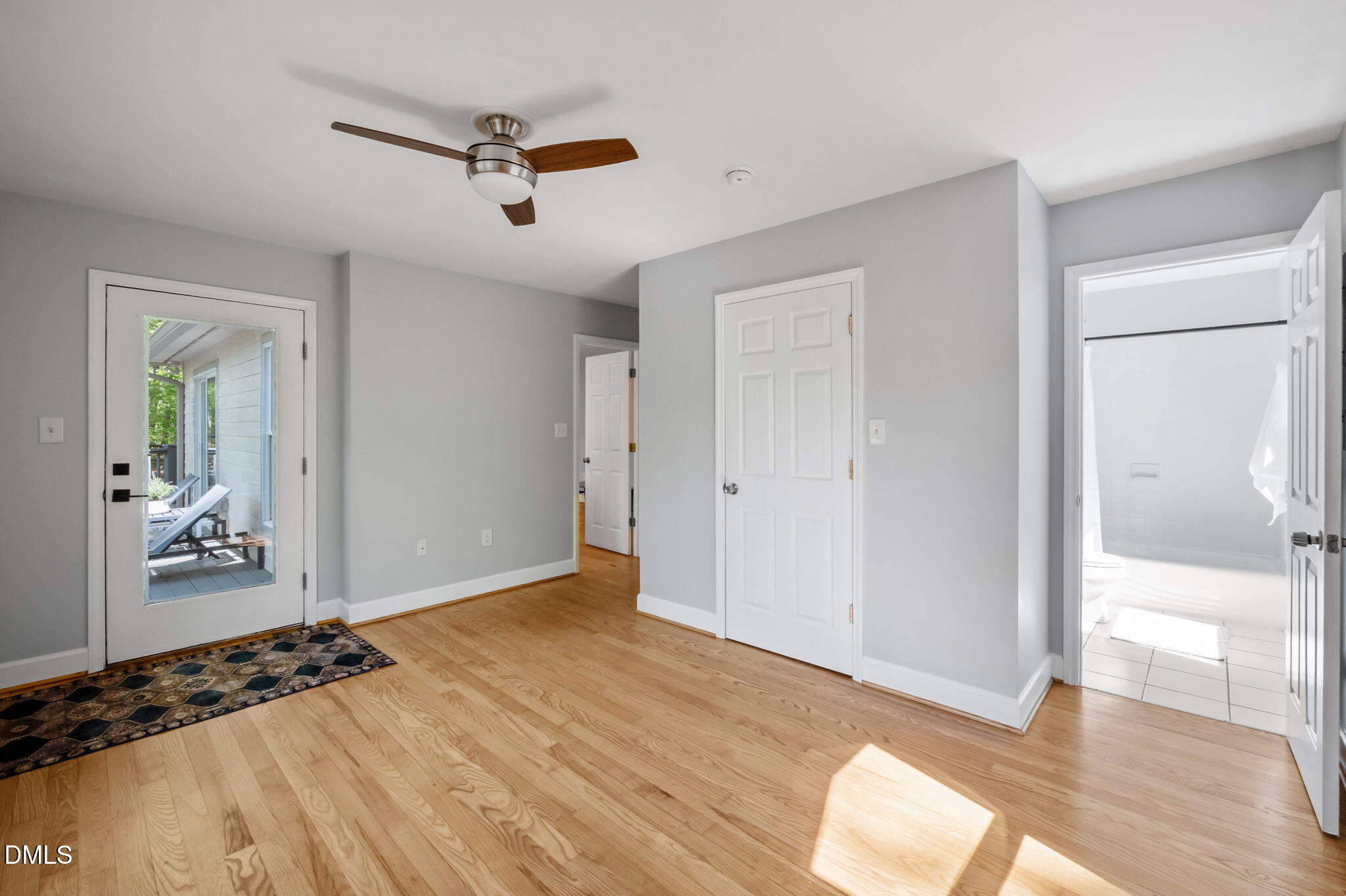 201 Simpson Street, Unit B Carrboro, NC 27510 - Photo 21 of 56 a view of a livingroom with wooden floor and a ceiling fan