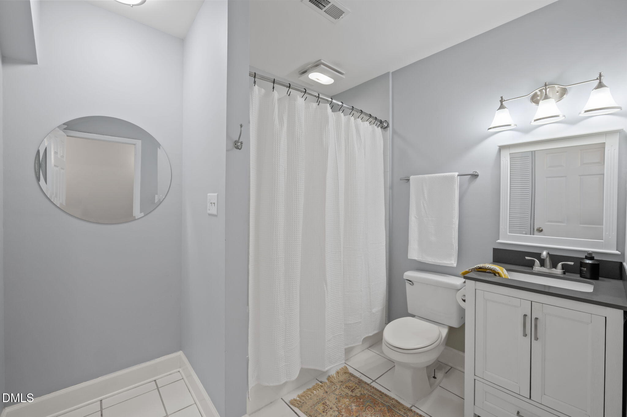 201 Simpson Street, Unit B Carrboro, NC 27510 - Photo 26 of 56 a bathroom with a toilet a sink and a mirror