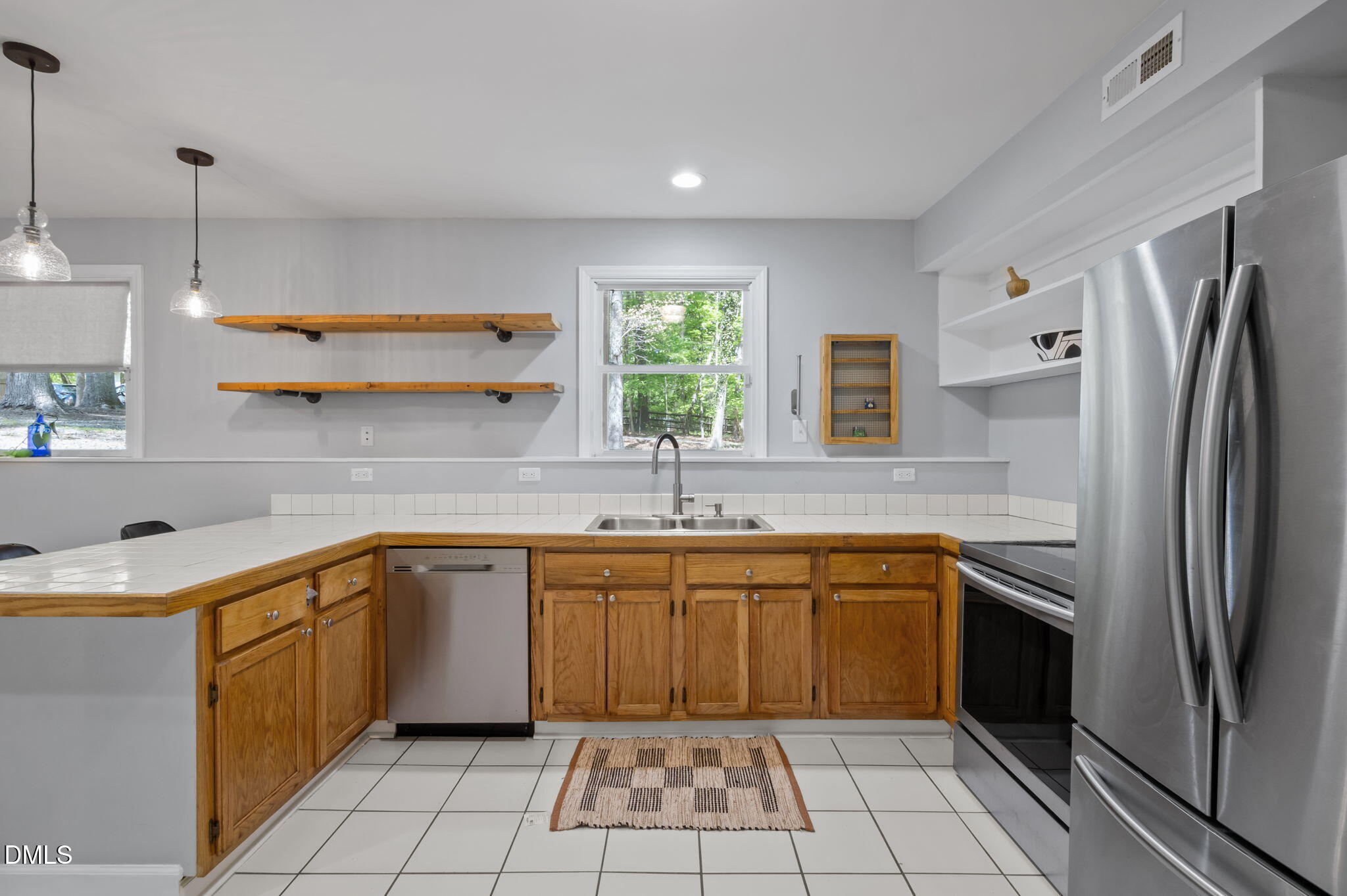 201 Simpson Street, Unit B Carrboro, NC 27510 - Photo 27 of 56 a kitchen with a sink stove and refrigerator