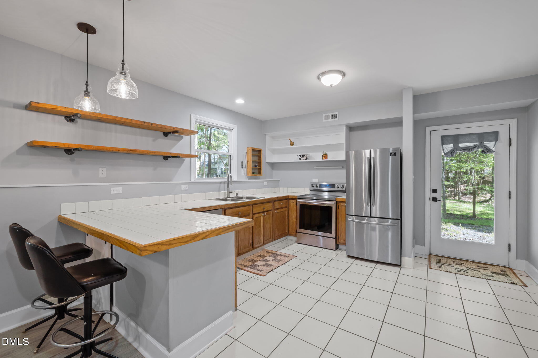 201 Simpson Street, Unit B Carrboro, NC 27510 - Photo 30 of 56 a kitchen with refrigerator and cabinets