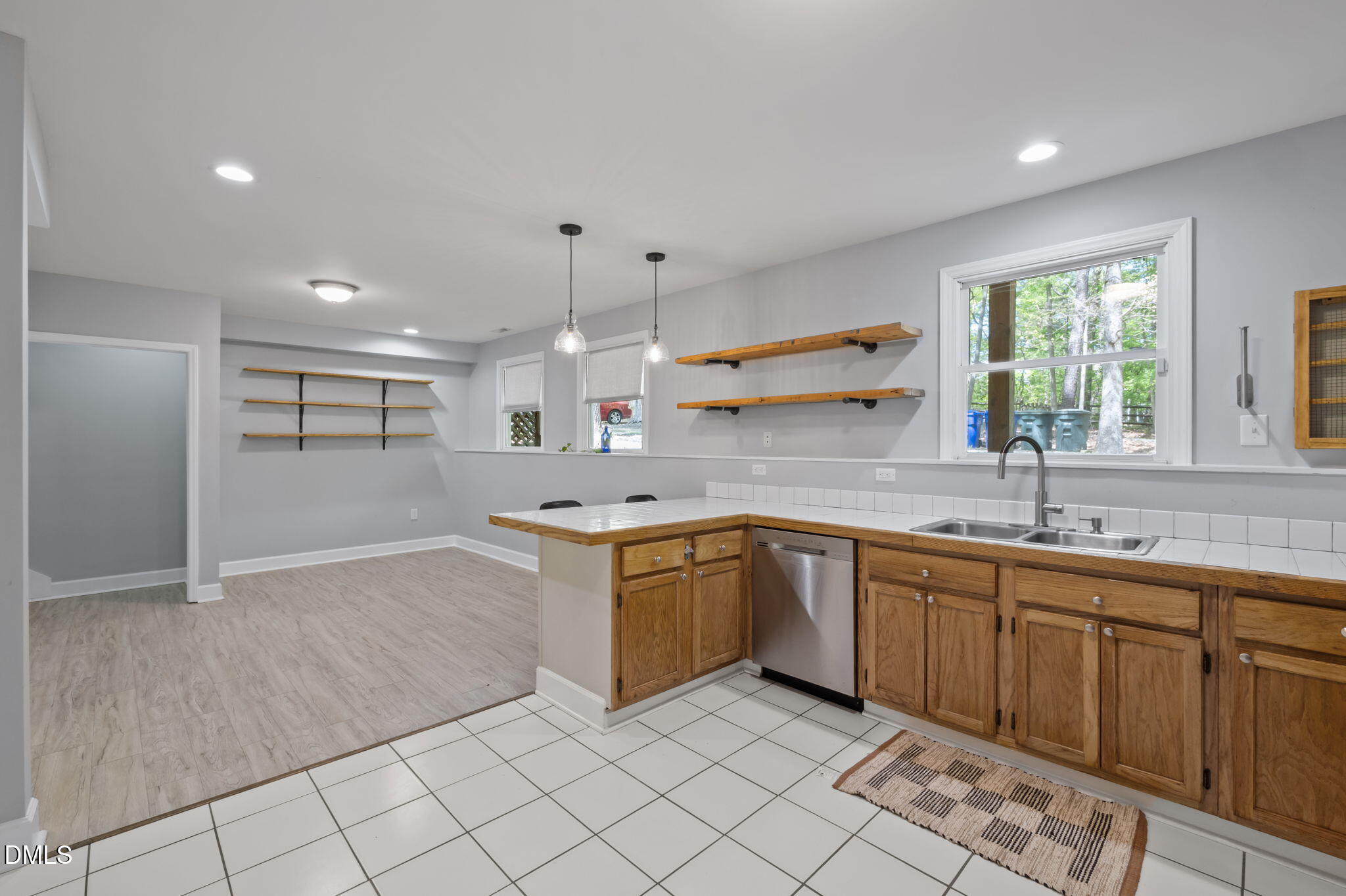 201 Simpson Street, Unit B Carrboro, NC 27510 - Photo 4 of 56 a kitchen with a sink window and cabinets