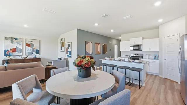 a view of a dining room with furniture wooden floor and chandelier