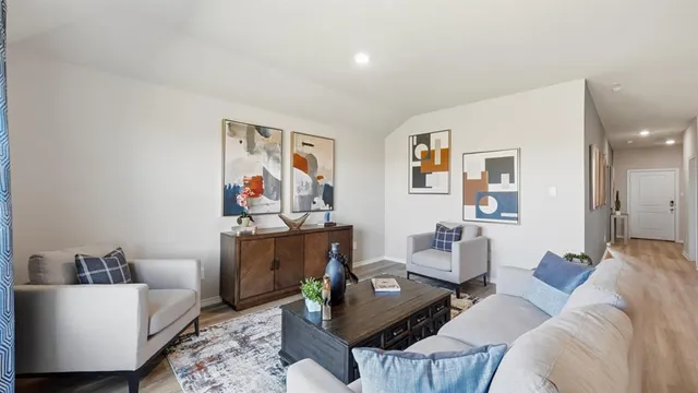 a living room with furniture and a potted plant