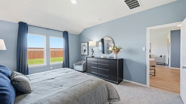 a bedroom with a bed and a potted plant