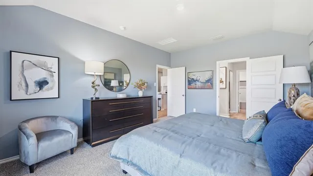 a bedroom with a bed and a lamp on table