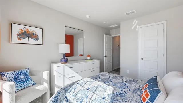 a bed sitting in a bedroom next to a window