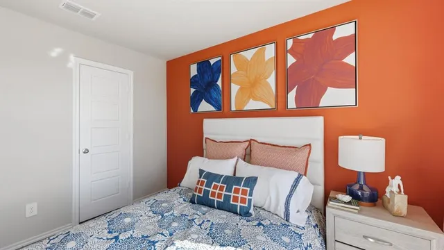 a bedroom with a bed and a large window