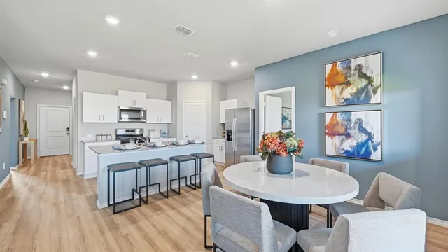 a kitchen with a stove a sink a refrigerator and cabinets