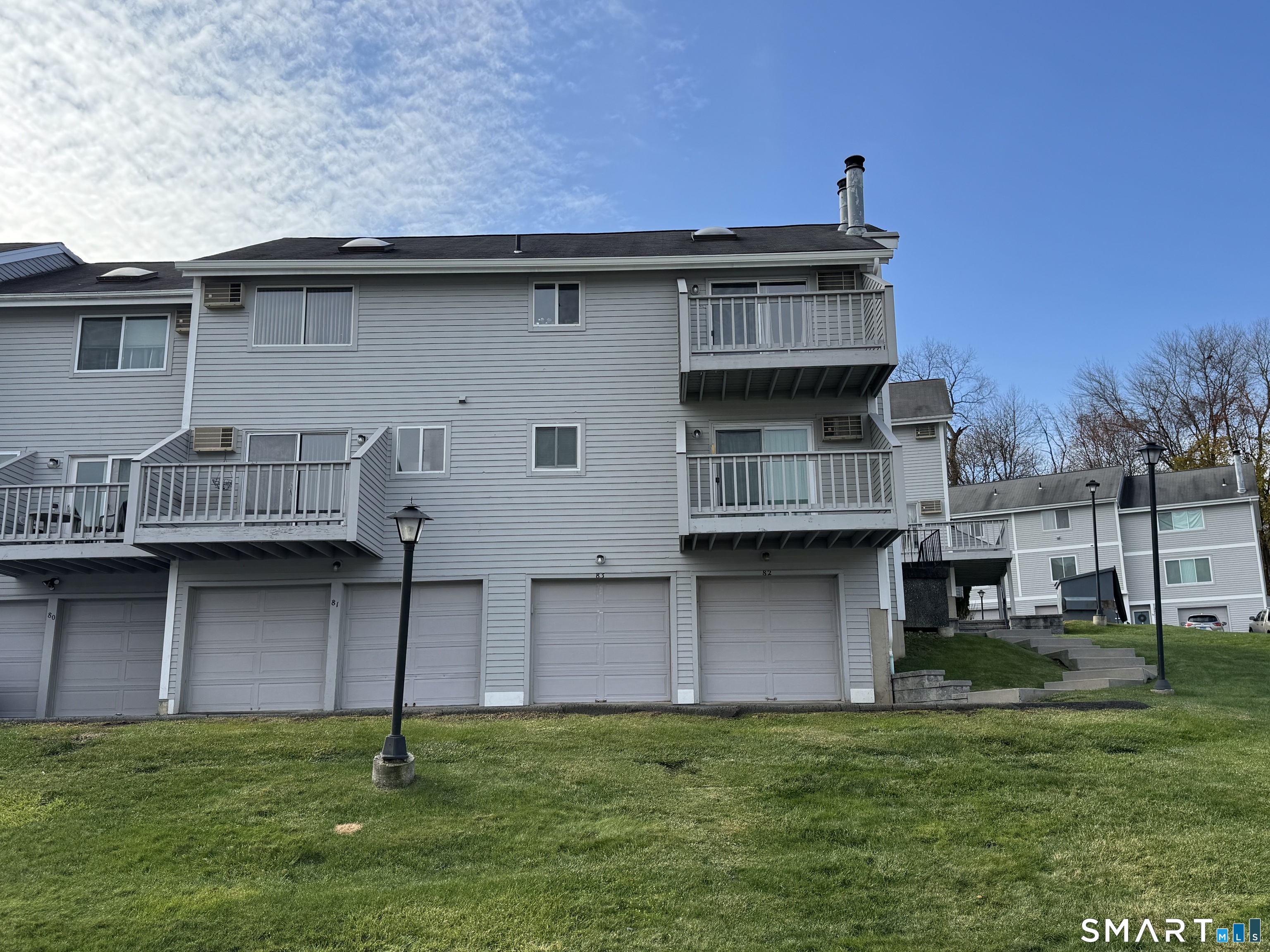151 Shelter Rock Road, Unit 81 Danbury, CT 06810 - Photo 3 of 4 a front view of a house with a garden