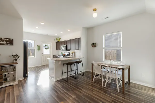 a view of a dining room with furniture window and wooden floor