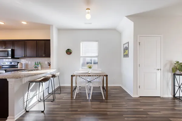 a view of a dining room with furniture wooden floor and a window