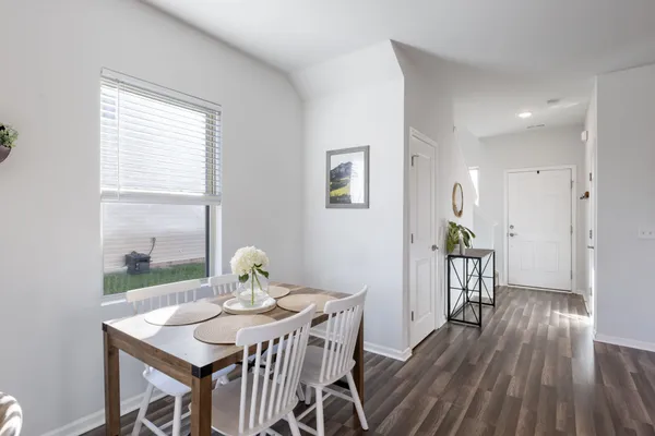 a view of a dining room with furniture and wooden floor