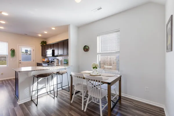 a view of a dining room with furniture and wooden floor