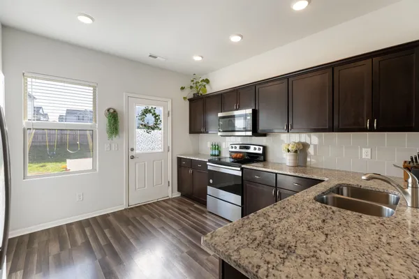 a kitchen with a sink stove and refrigerator