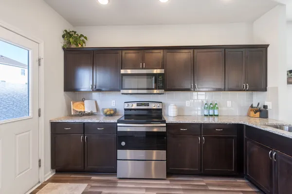 a kitchen with a sink and a stove top oven