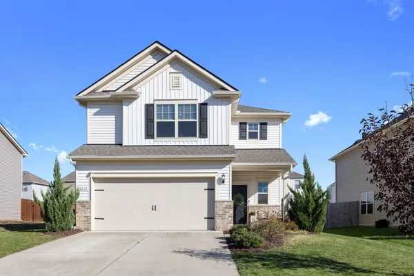 a front view of a house with a yard and garage