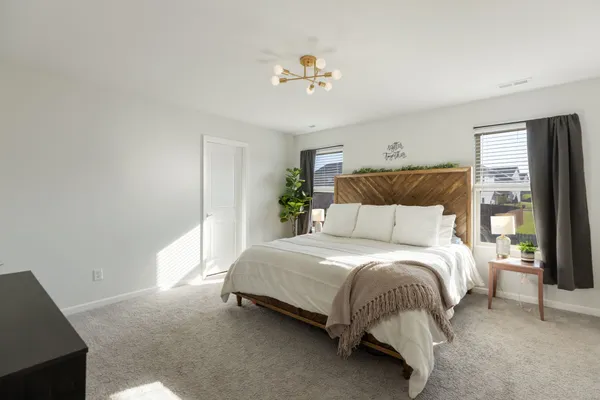 a spacious bedroom with a bed and window